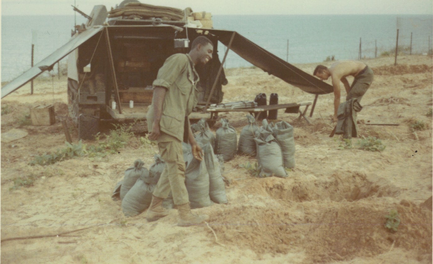 J Abron & Brischke filling sand bags overlooking South China Sea